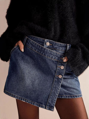 Dark blue denim skort with asymmetrical button-front detail and frayed hem