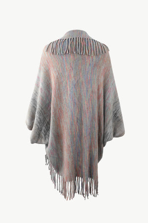 Textured stripe fringe cape in multicolor acrylic with fringe detail.