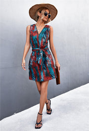 Floral zip-front tie-waist mini dress in White/Red with a tropical leaf print and V-neck.