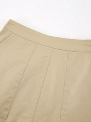 High-waisted beige cotton A-line skirt with pockets and stitched panel details.