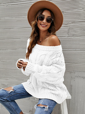 White cable knit off-shoulder slouch sweater with open knit details and long sleeves.