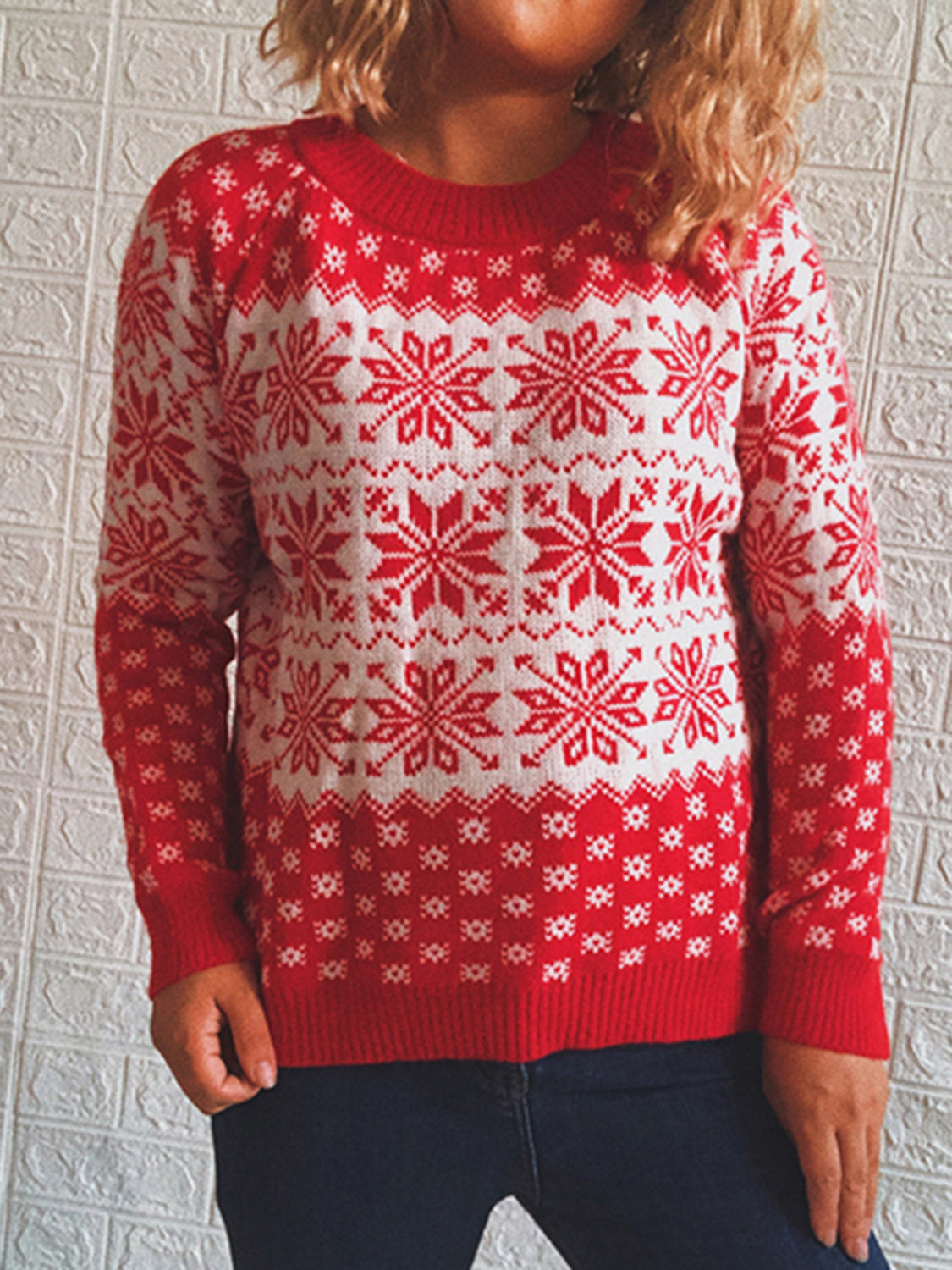 Red and white snowflake knit pullover sweater with crew neck.