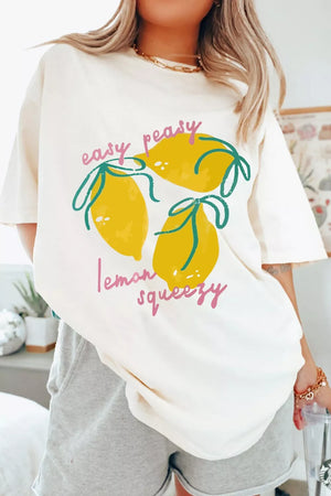 Cream polyester t-shirt with a graphic of three lemons and text that says "easy peasy lemon squeezy".