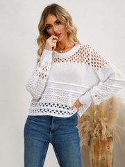 White openwork knit sweater with crew neck and long sleeves, featuring textured details.