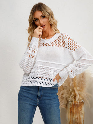 White openwork knit sweater with crew neck and long sleeves, featuring textured details.