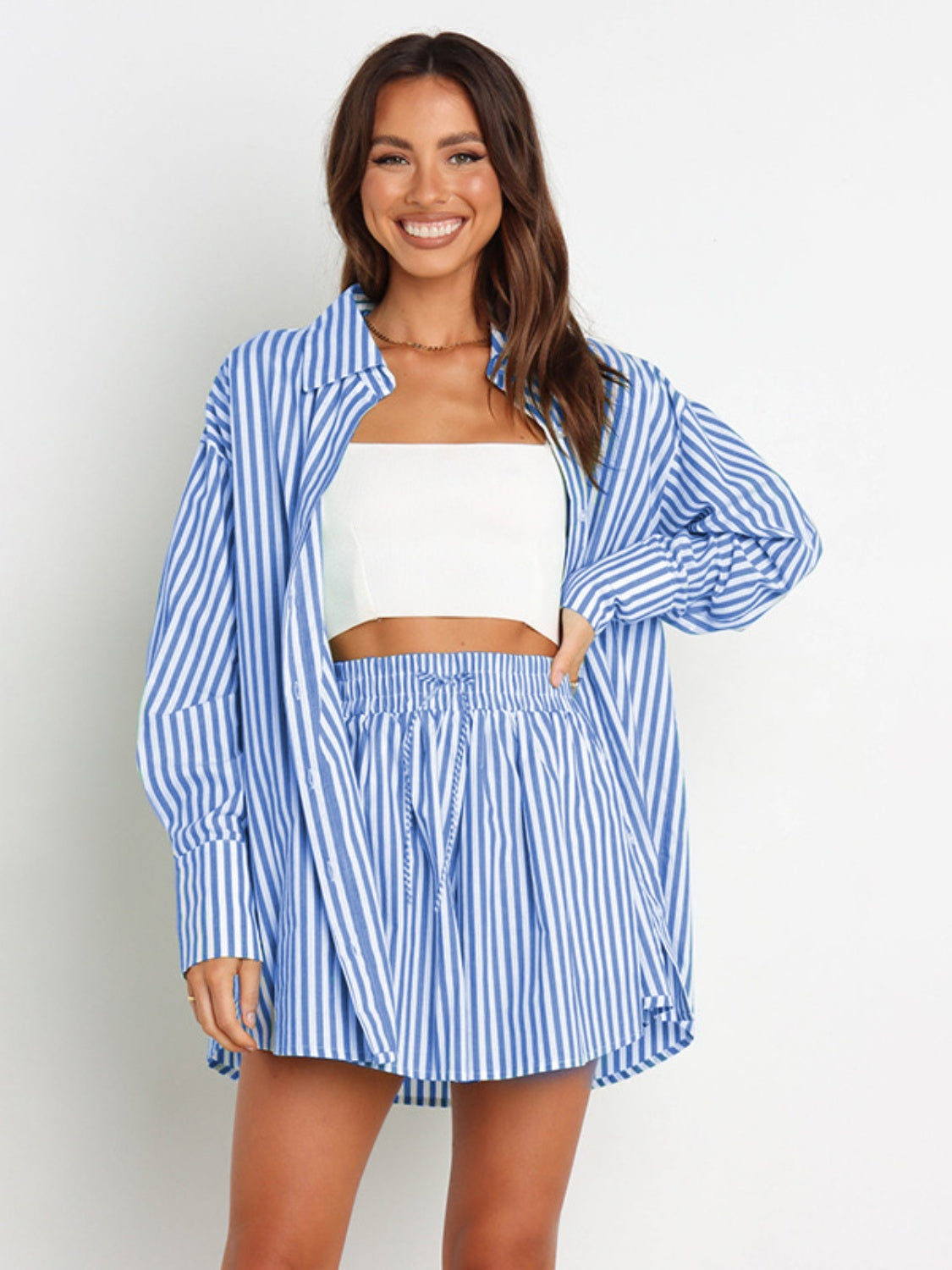Light blue and white striped oversized shirting set with drawstring shorts.