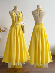 Yellow Swiss dot halter maxi dress with a-line skirt and smocked waist.