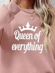 Blush pink graphic sweatshirt with white "Queen of everything" text and crown graphic.