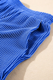 Royal blue textured ribbed polo short set with a close-up view of the fabric detail.