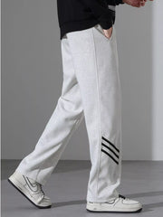 Light Flower Gray sweatpants with black side stripes and a loose fit.