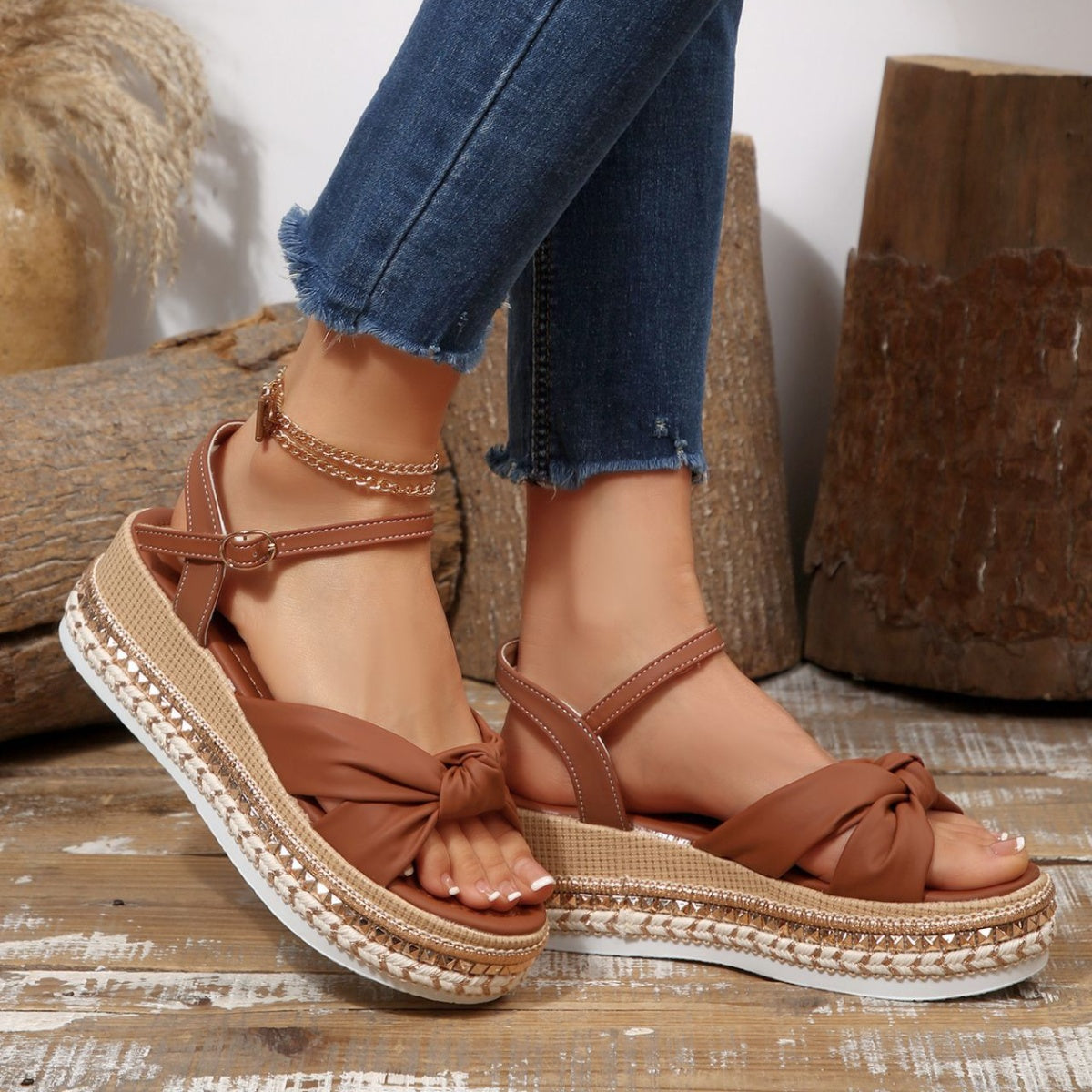Brown bow knot wedge sandals with braided trim and ankle buckle.