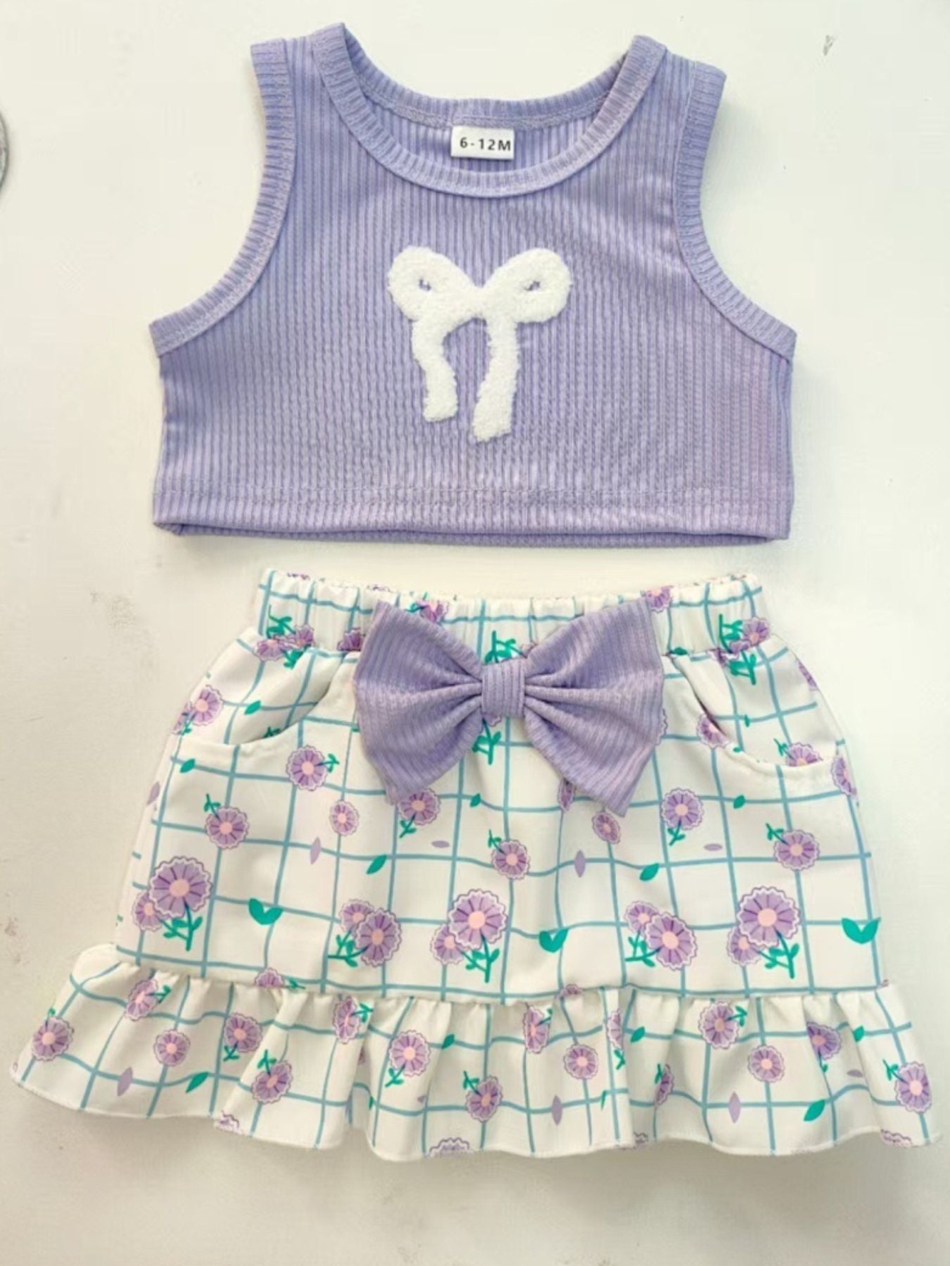 Lavender ribbed tank top with white bowknot and floral print skirt with purple bowknot