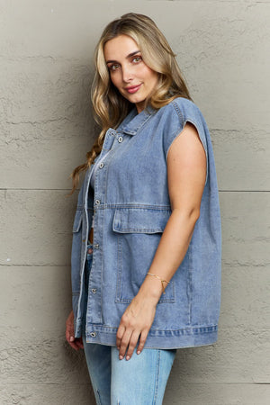 Light wash denim utility vest with collared neck and oversized chest pockets.