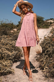Pink halter neck tiered mini dress with bow back detail