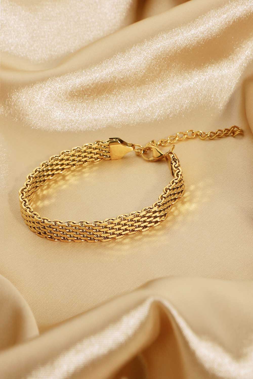 Gold woven chain bracelet with adjustable clasp and extender chain.