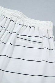 White polyester bikini shorts with black stripes and drawstring waist.