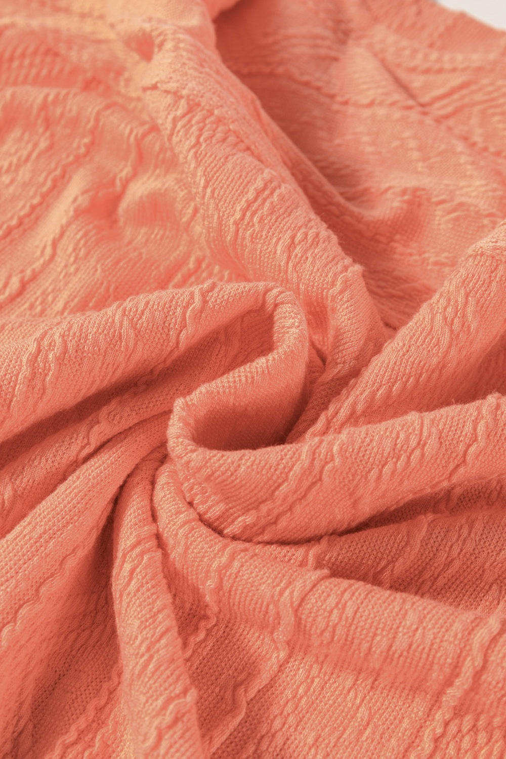 Textured knit drawstring short set in sherbet, showing fabric detail.