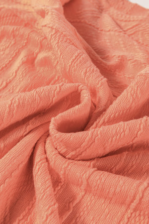 Textured knit drawstring short set in sherbet, showing fabric detail.