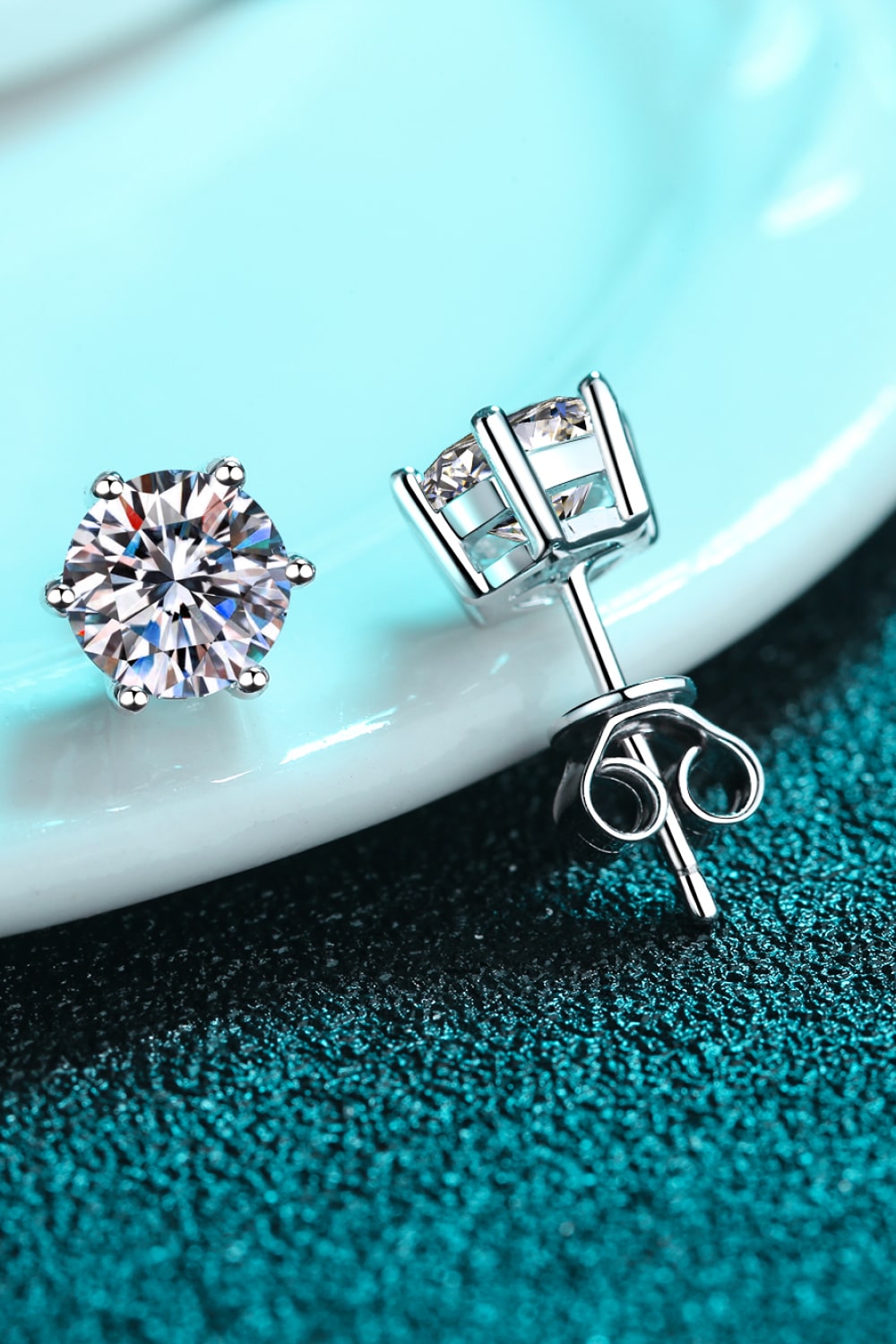 Silver six-prong moissanite solitaire stud earrings in 925 sterling silver.