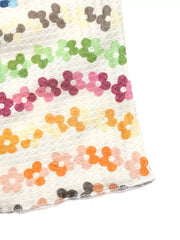 Vibrant floral ruching tank top with daisy pattern in pastel colors.