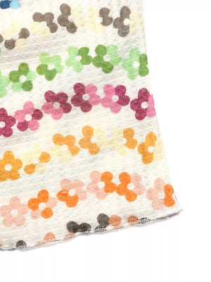 Vibrant floral ruching tank top with daisy pattern in pastel colors.