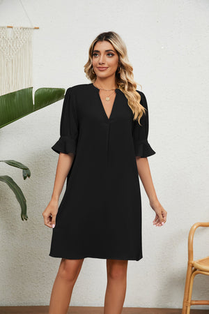 Black V-neck shift dress with flutter sleeves and a relaxed fit.