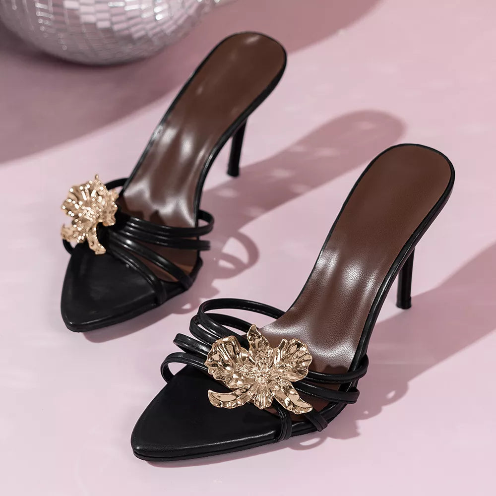 Black high heel sandals with gold floral embellishments and strappy detail.