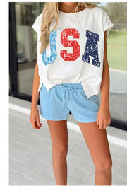 White dolman t-shirt with USA lace graphic, short sleeves, and tie waist.
