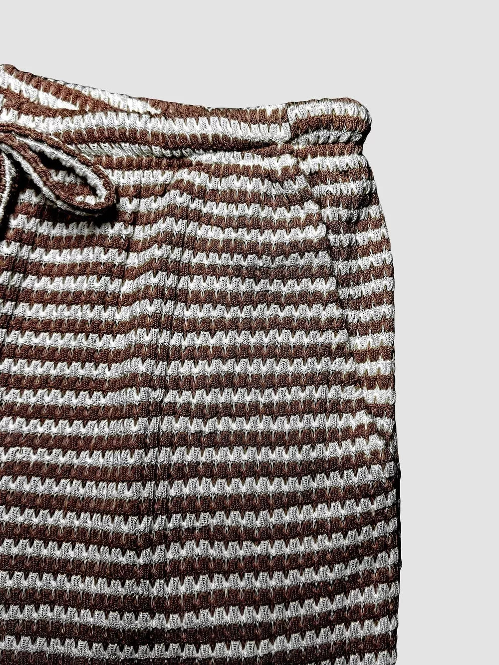 Maternity wide leg trousers in dark brown and white stripe pattern with drawstring waist.