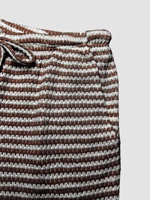 Maternity wide leg trousers in dark brown and white stripe pattern with drawstring waist.