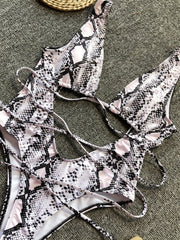 Snakeskin print one-piece swimsuit with plunging neckline and crisscross back ties.