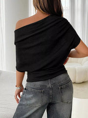 Black ruched off-shoulder knit t-shirt with draped neckline and short sleeves.