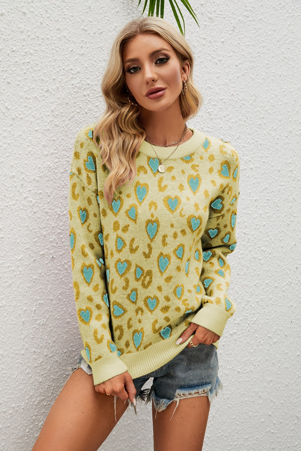 Light Yellow heart print drop shoulder sweater with crew neck and long sleeves.