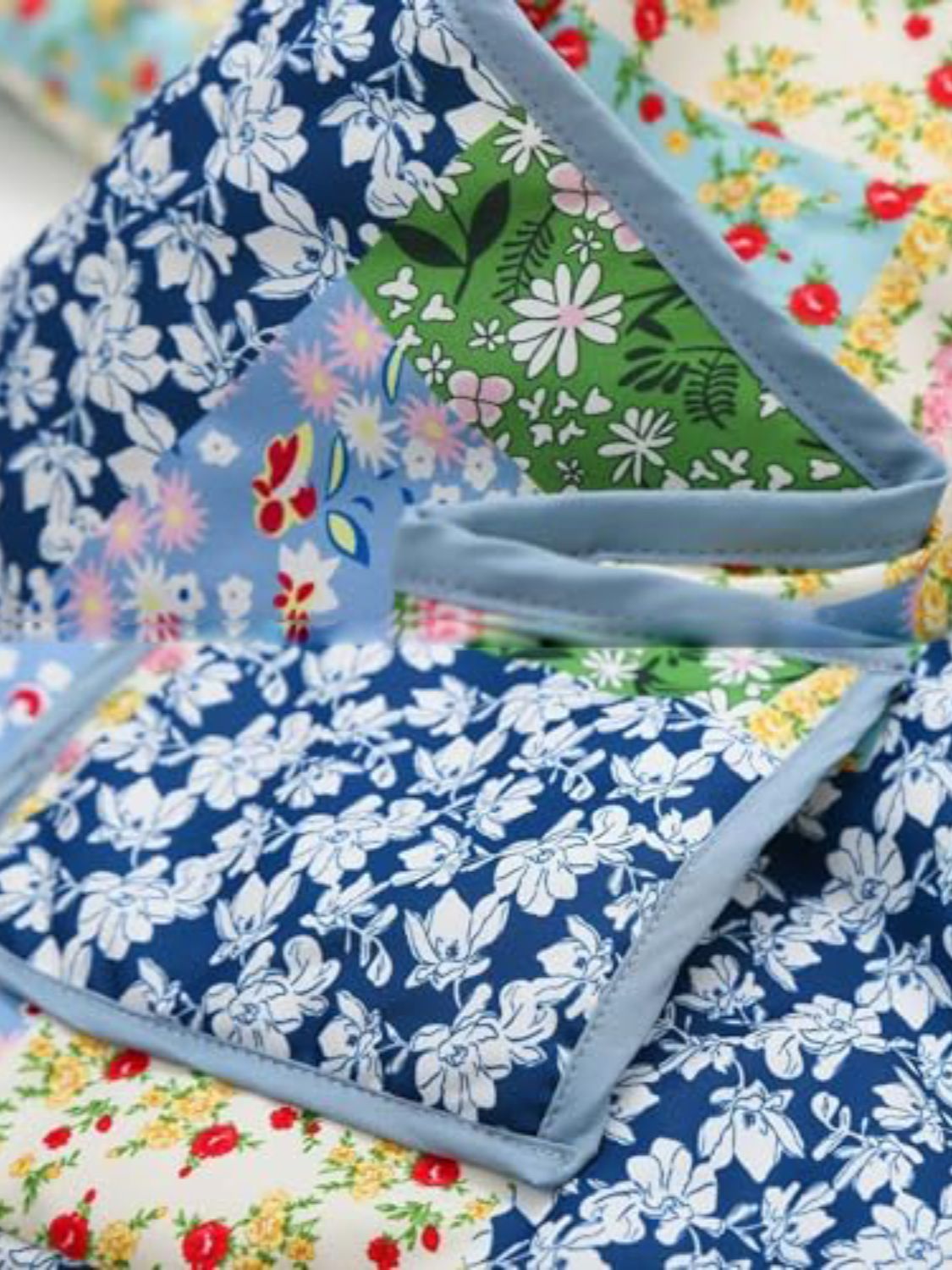 Floral quilted patchwork jacket with blue, green, and pink floral prints.