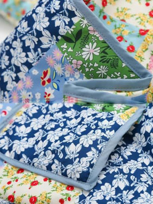 Floral quilted patchwork jacket with blue, green, and pink floral prints.