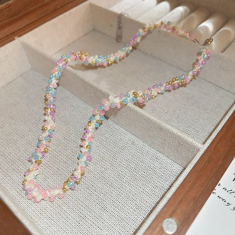Pastel petal chain necklace with pink, purple, and blue beads and gold accents