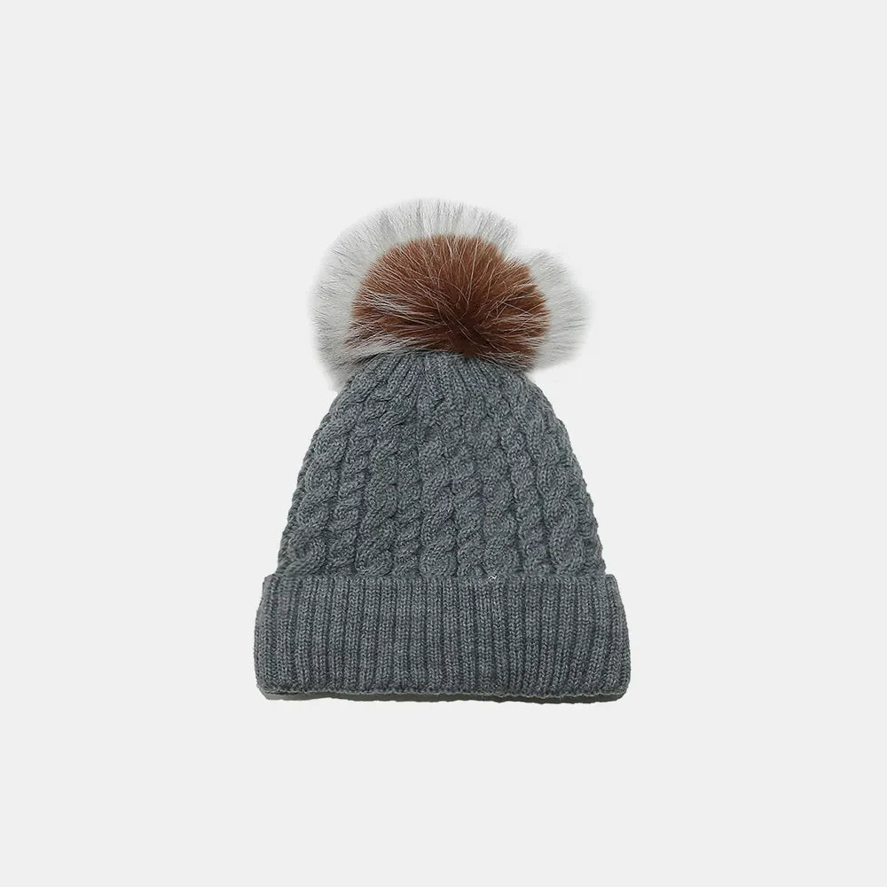 Dark Gray acrylic cable knit beanie with a fluffy pompom.
