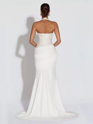 White sequin halter neck maxi gown with corset back and draped skirt.