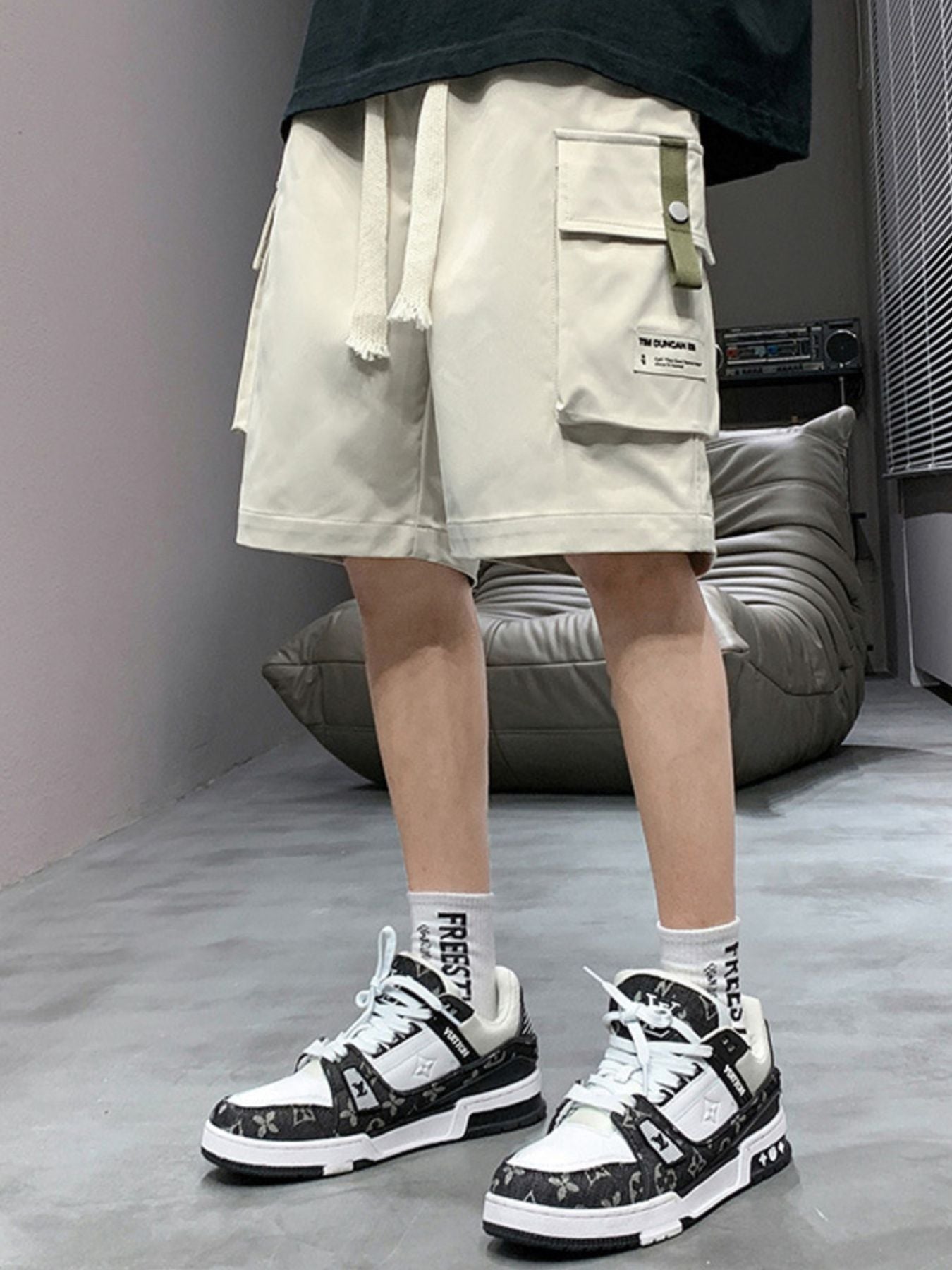 Men's apricot lightweight cargo shorts with drawstring and multiple pockets.