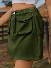 Dark green denim mini skirt with elastic waist and button, featuring multiple cargo pockets.