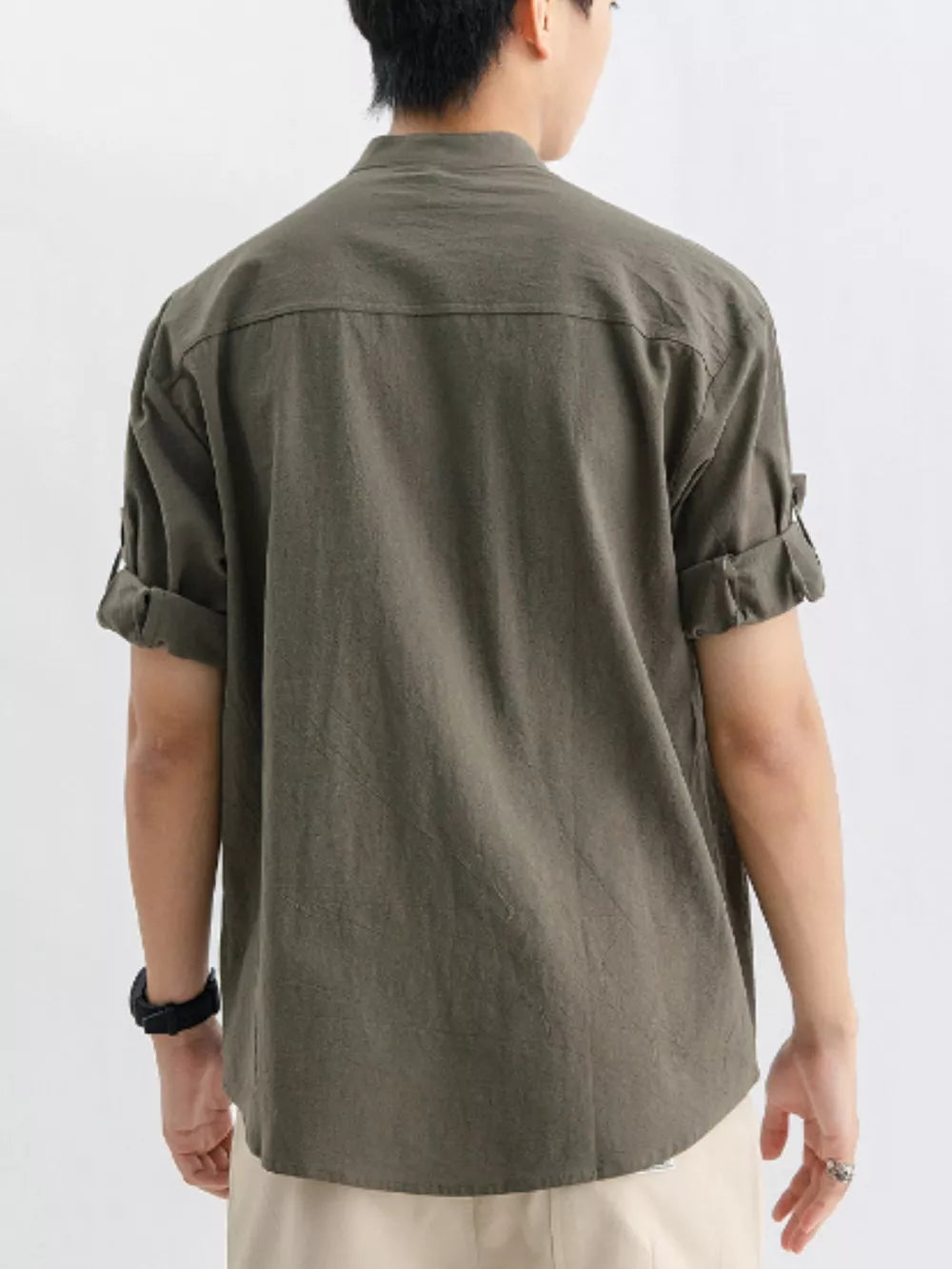 Relaxed fit button-up shirt in dark green with rolled sleeves and a chest pocket.