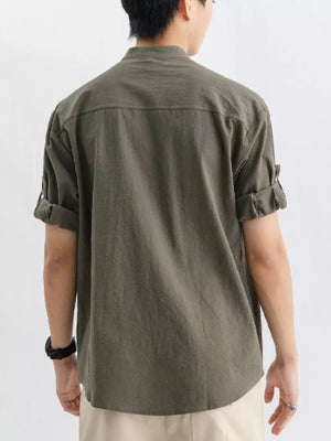 Relaxed fit button-up shirt in dark green with rolled sleeves and a chest pocket.