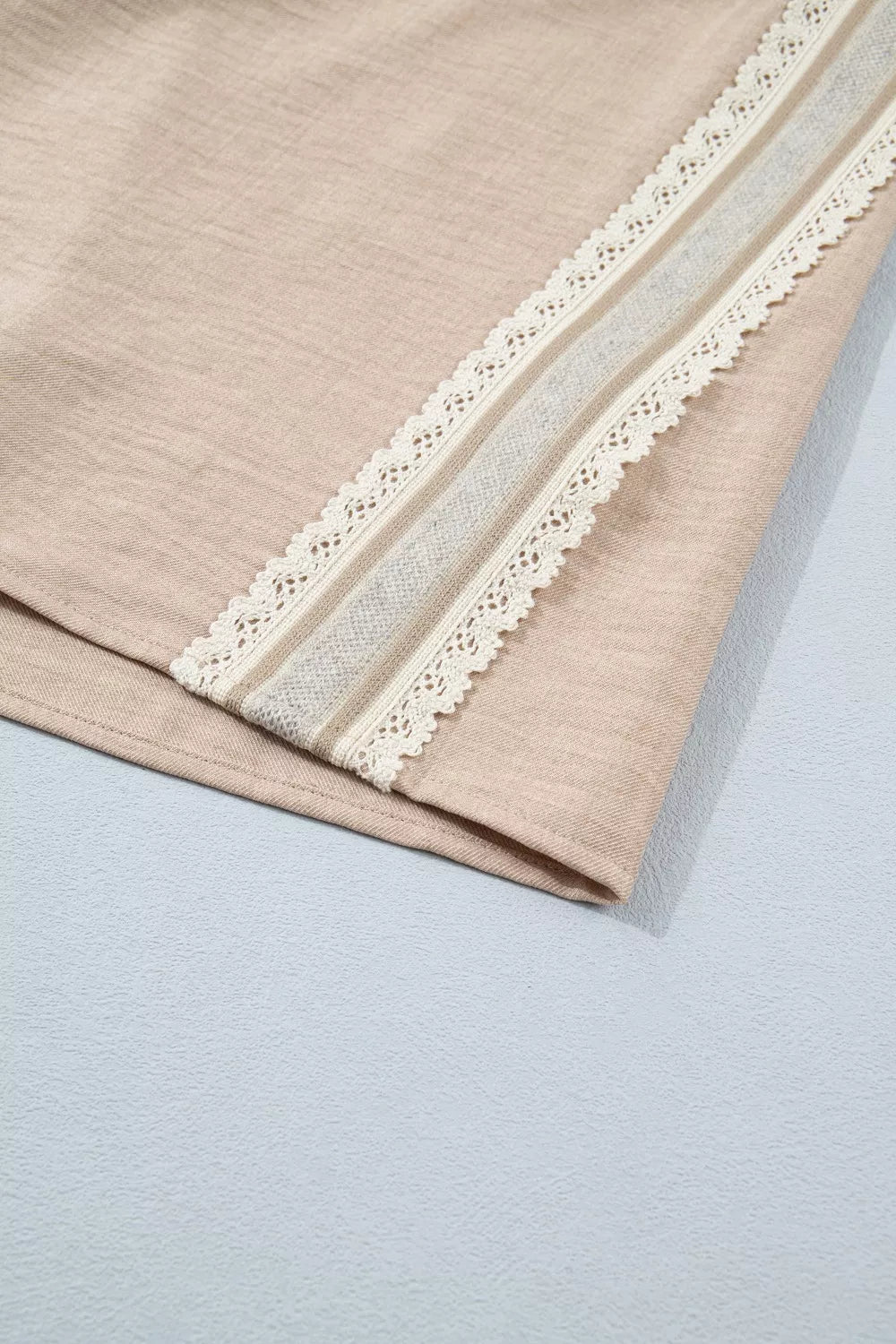 Beige knit pullover with crochet lace trim and rolled sleeves detail
