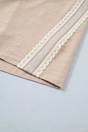 Beige knit pullover with crochet lace trim and rolled sleeves detail