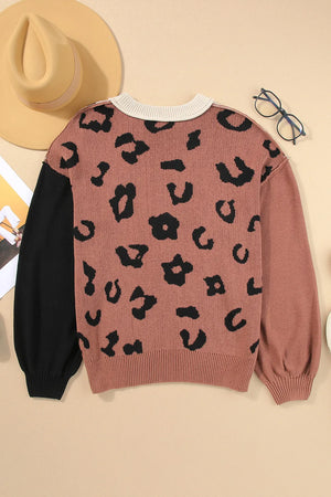 Colorblock leopard print knit sweater with black sleeves and crew neck.