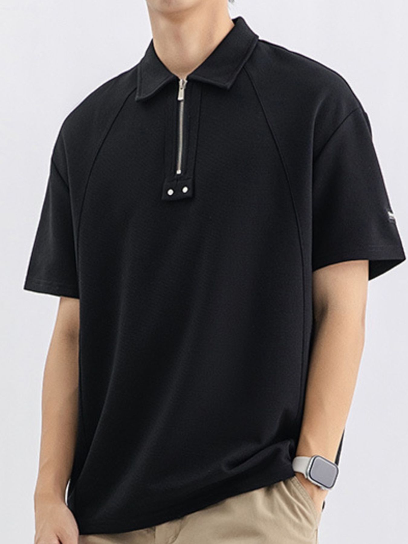 Black cotton polo with half-zip and metallic accents