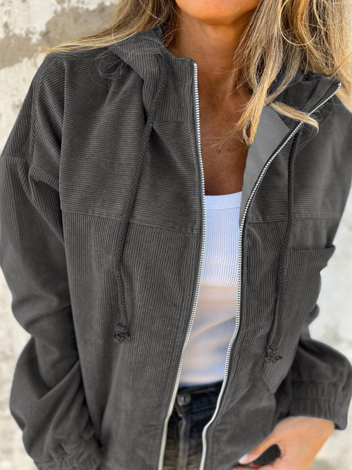 Dark gray corduroy relaxed fit zip-up hoodie with drawstring hood and pockets.
