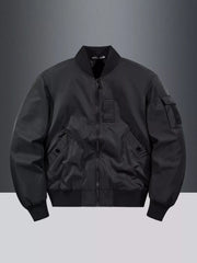 Classic black bomber jacket with zip front, ribbed collar, cuffs, and hem, and utility pockets.