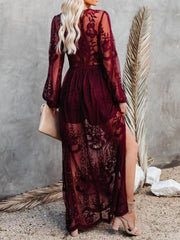 Burgundy floral lace maxi dress with long sleeves, high slit, and sheer overlay.