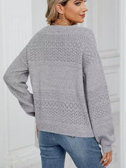Light gray eyelet stitch V-neck pullover sweater with textured knit details.